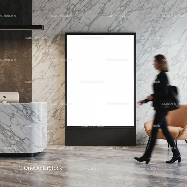 Woman walking past empty advertisement board in marble lobby JPG Mockup Image