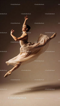 Graceful ballet dancer leaping in soft studio light
