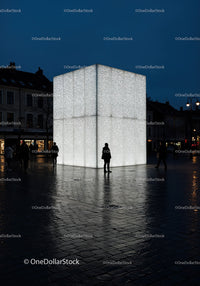 Illuminated Large Cube Art Installation in Urban Night Scene