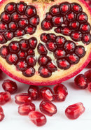 Close Up of Fresh Pomegranate Seeds and Fruit Half
