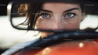 Close-up of Young Woman with Blue Eyes and Freckles Behind Car Windows