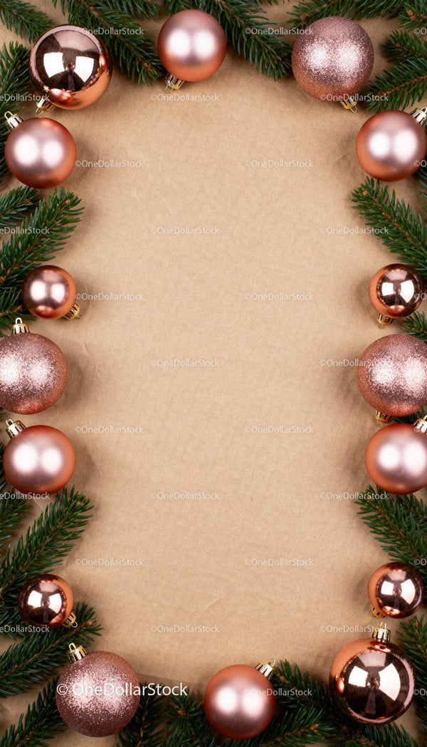 Festive Christmas ornaments and pine frame on kraft paper