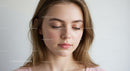 Young Woman with Smooth Skin and Soft Expression in Bright Portrait