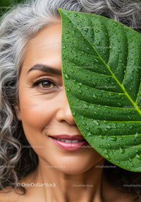 Close-Up of Smiling Woman Holding Water Droplet Covered Leaf