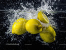 Juicy Yellow Lemons Splashing into Water Creating Vibrant Scene