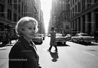 Elegant Elderly Woman Walking Through Busy City Street in Black and White