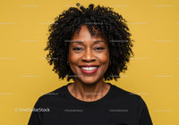 Vibrant Portrait of a Smiling Black Woman with Curly Hair on Yellow Background
