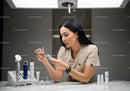 Woman Applying Skincare Routine with Modern Cosmetic Devices in Spa