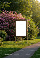 Blank wooden signboard in vibrant garden pathway
