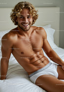 Smiling man relaxing on bed in white underwear