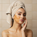 Young Woman with Facial Mask and Towel after Beauty Treatment