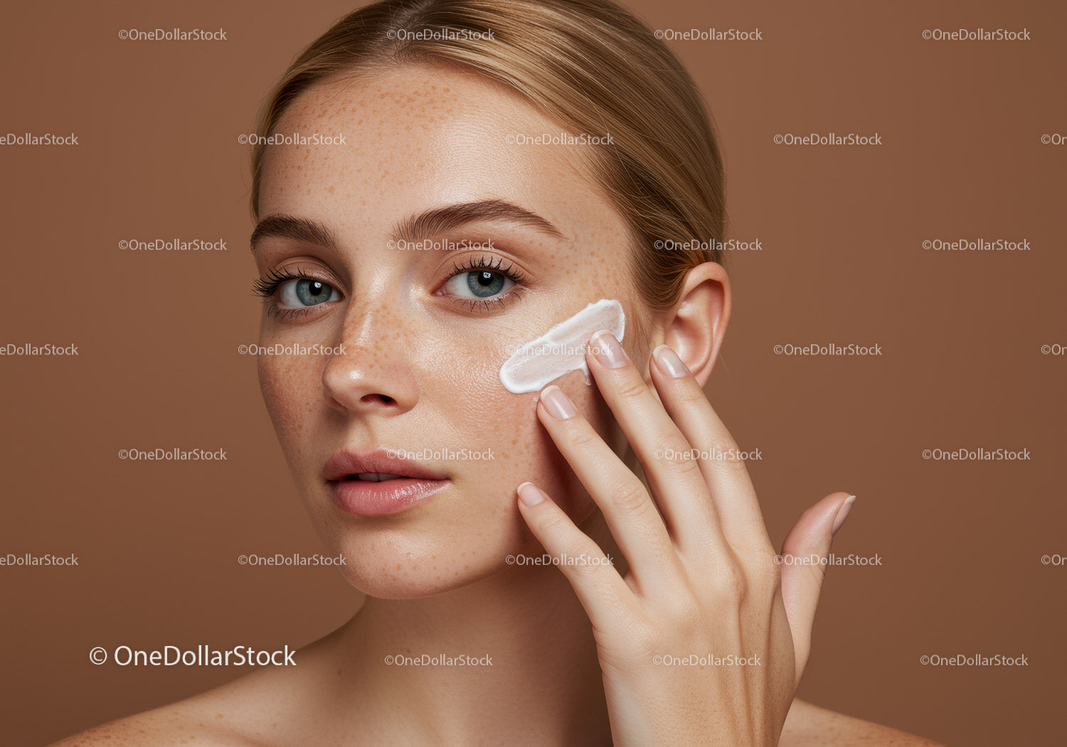 Young Woman Applying Skincare Cream with Clear Skin and Freckles