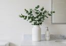 Elegant Green Foliage in White Vase on Marble Bathroom Counter
