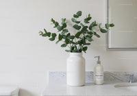 Elegant Green Foliage in White Vase on Marble Bathroom Counter