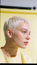 Young woman with short platinum hair in soft light