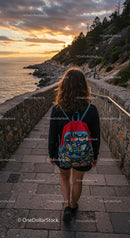 Young woman walking along scenic rocky coastline path