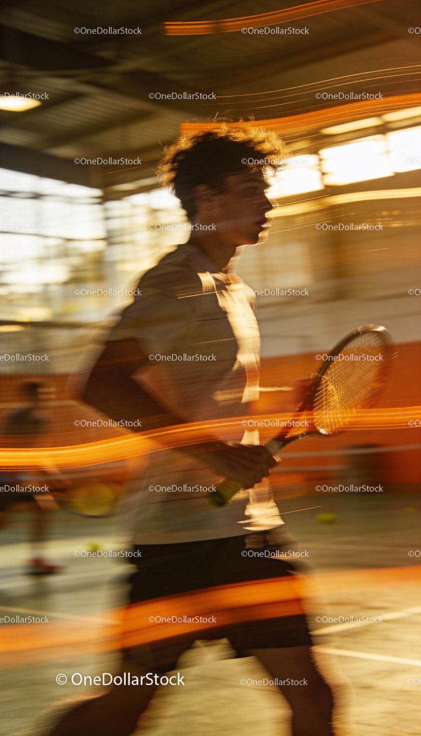 Young tennis player moving swiftly during indoor game