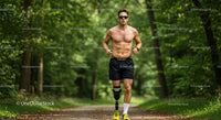 Male Runner with Prosthetic Leg Running Through Green Forest