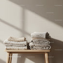 Neatly Folded Natural Textile Stack on Wooden Bench