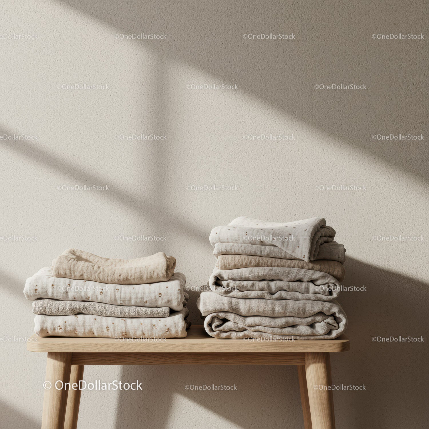 Neatly Folded Natural Textile Stack on Wooden Bench