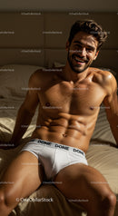 Smiling young man relaxing on bed in bright underwear
