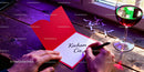 Writing a romantic love note on red heart card