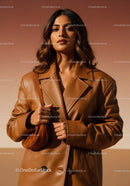 Stylish Woman in Brown Leather Coat Posing Against Beige Background