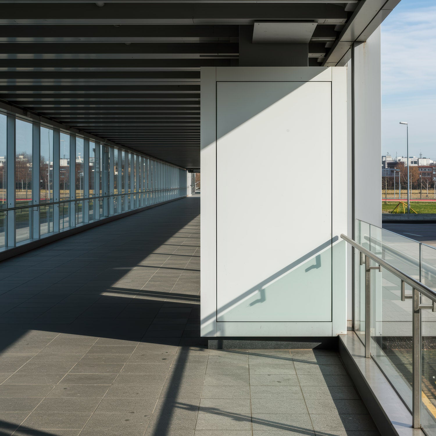 Modern corridor with glass walls and natural light shadows