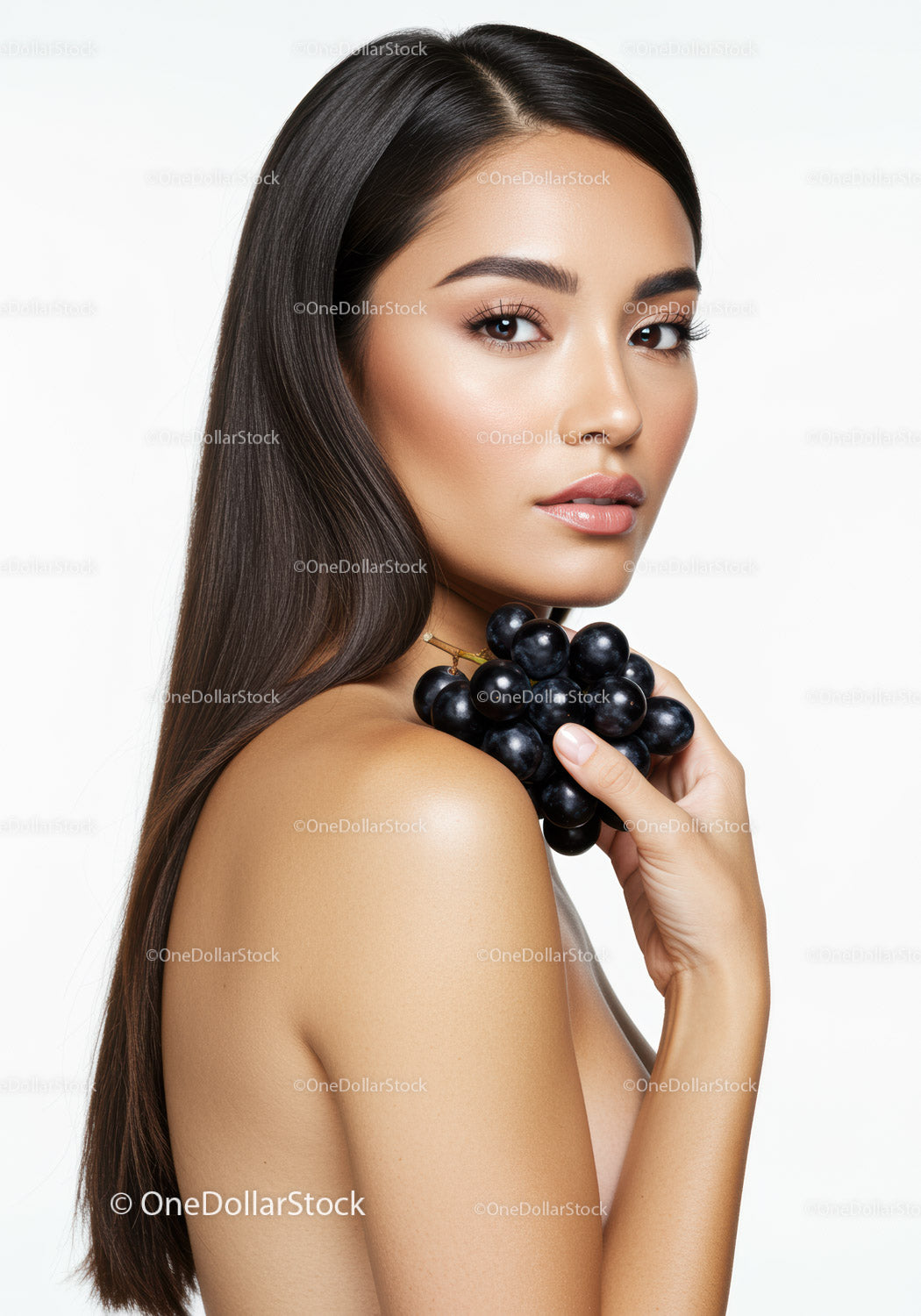 Elegant Woman Holding Black Grapes with Perfect Skin and Long Hair