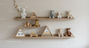 Adorable Plush Toys and Wooden Decorations on Nursery Shelves