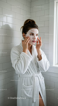 Woman Applying Face Mask in Bathroom For Skin Rejuvenation