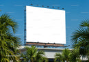 Large blank billboard in sunny tropical urban setting