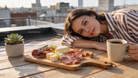 Relaxed woman enjoying charcuterie and coffee outdoors