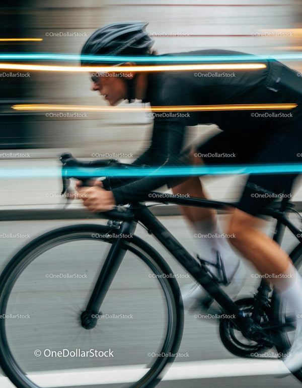 Focused cyclist riding fast on urban street
