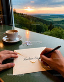 Writing a heartfelt love letter with scenic sunset view