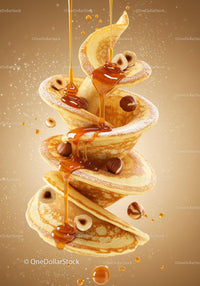 Flowing honey over stacked pancakes with hazelnuts