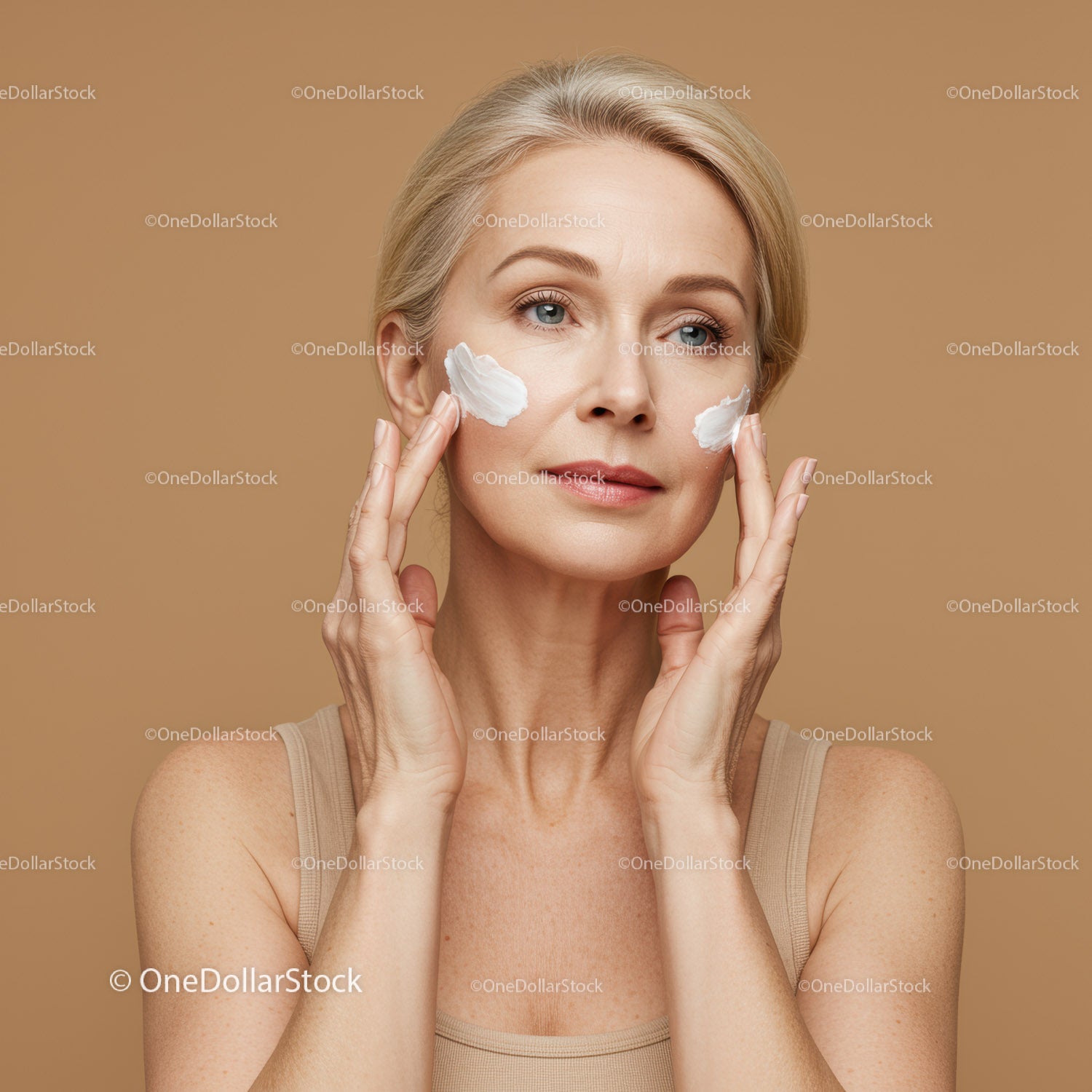 Elegant Mature Woman Applying Moisturizer for Youthful Skin