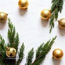 Elegant Gold Ornaments and Greenery on White Background