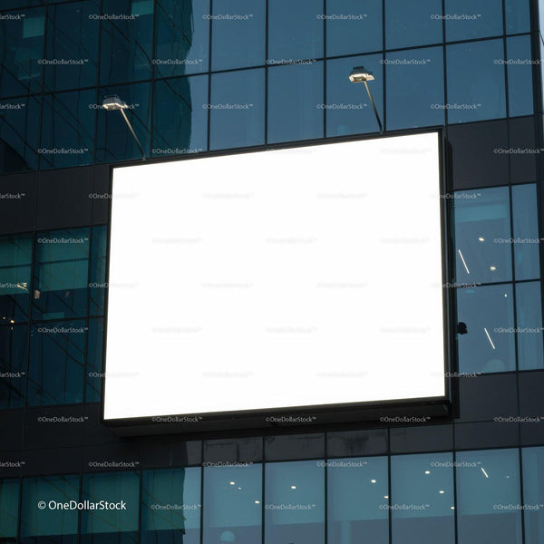 Blank illuminated billboard on modern glass building facade JPG Mockup Image