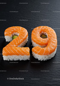 Creative sushi shaped as number twenty nine on black slate
