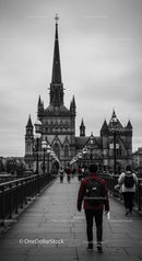 Historic Gothic Church with Tall Spire and Pedestrian Bridge in City