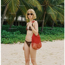 Woman in Bikini with Red Tote Bag on Tropical Beach with Palm Trees