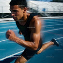 Focused athlete sprinting intensely on outdoor track