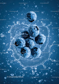 Fresh blueberries splashing into clear water