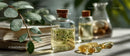 Herbal Oil in Glass Bottles with Green Leaves and Capsules