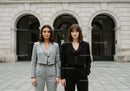 Fashionable Women Standing in Front of Historic City Building