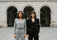 Fashionable Women Standing in Front of Historic City Building