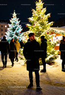 Man enjoying winter evening at festive Christmas market