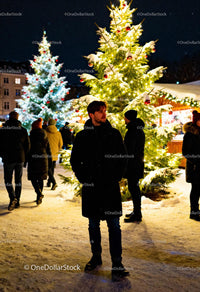 Man enjoying winter evening at festive Christmas market