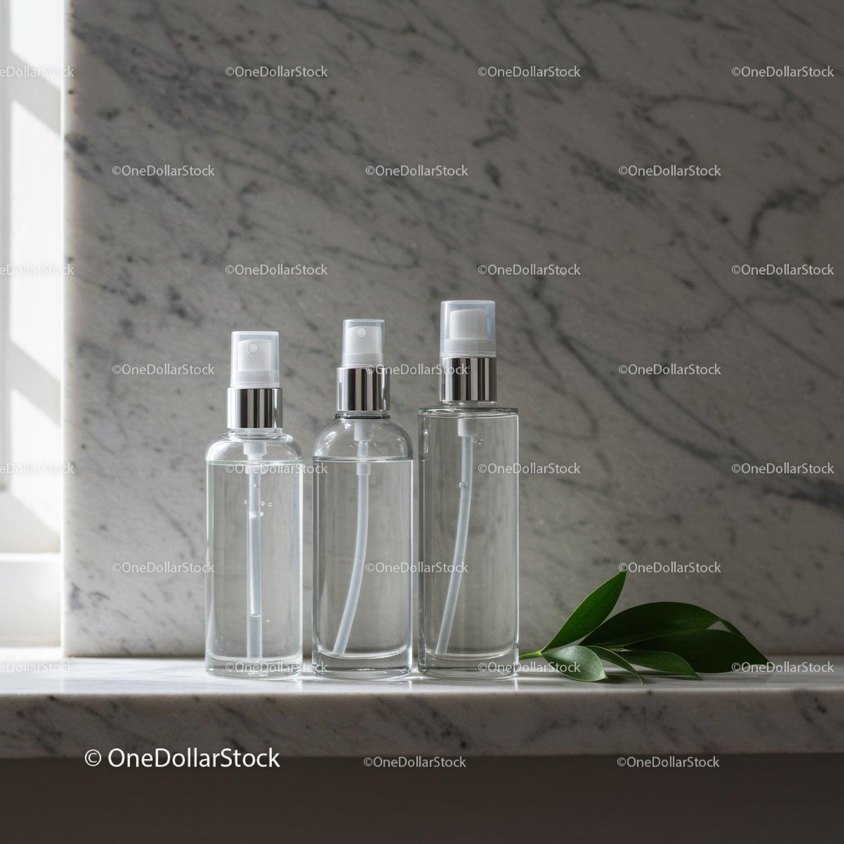 Clear Spray Bottles on Marble Surface with Green Leaves JPG Mockup Image preview